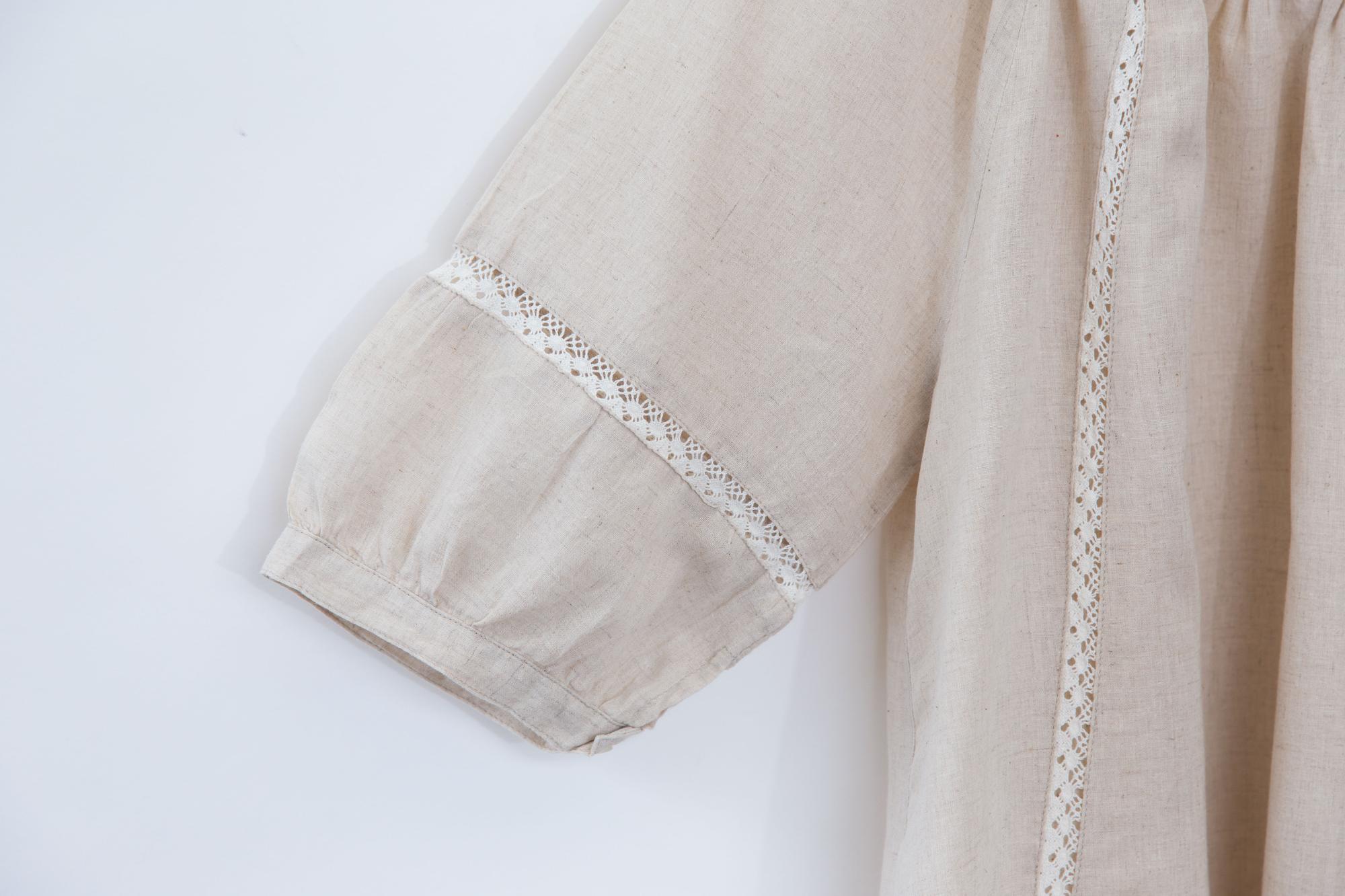 Embroidered cuff detail on linen blouse